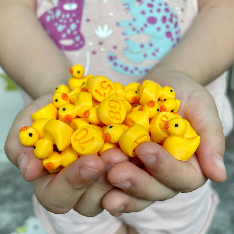 Child holding a handful of small yellow numbered ducks in their hands