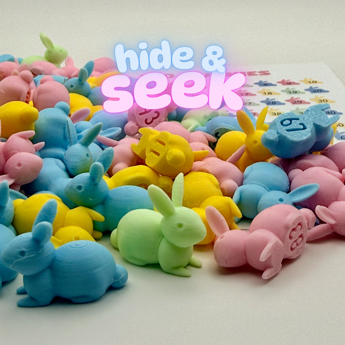 Close-up of pastel pink, blue, yellow and mint numbered bunnies with a tracking sheet in the background