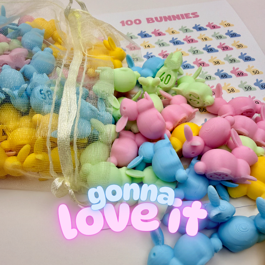 Pastel numbered bunnies spilling out of a sheer mesh bag next to a 100 Bunnies tracking sheet